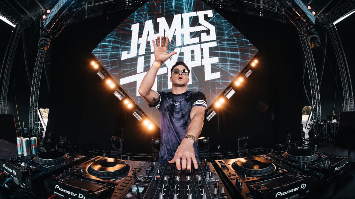 James Hype performing live behind a four-deck Pioneer DJ setup.