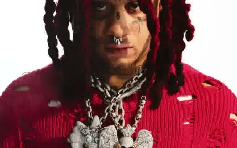Trippie Redd portrait in red sweater with chain necklaces